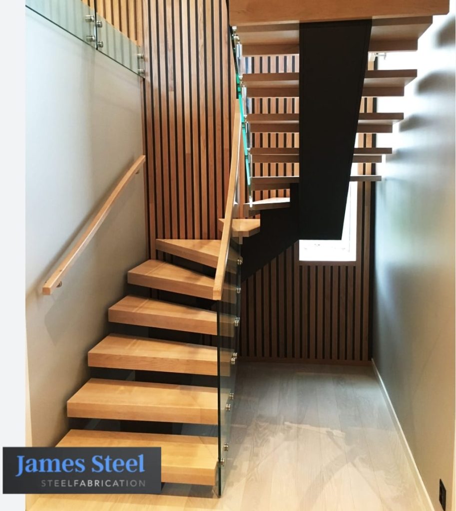 Bespoke mono stringer steel staircase with oak treads and glass balustrade fabricated for a London residential interior.